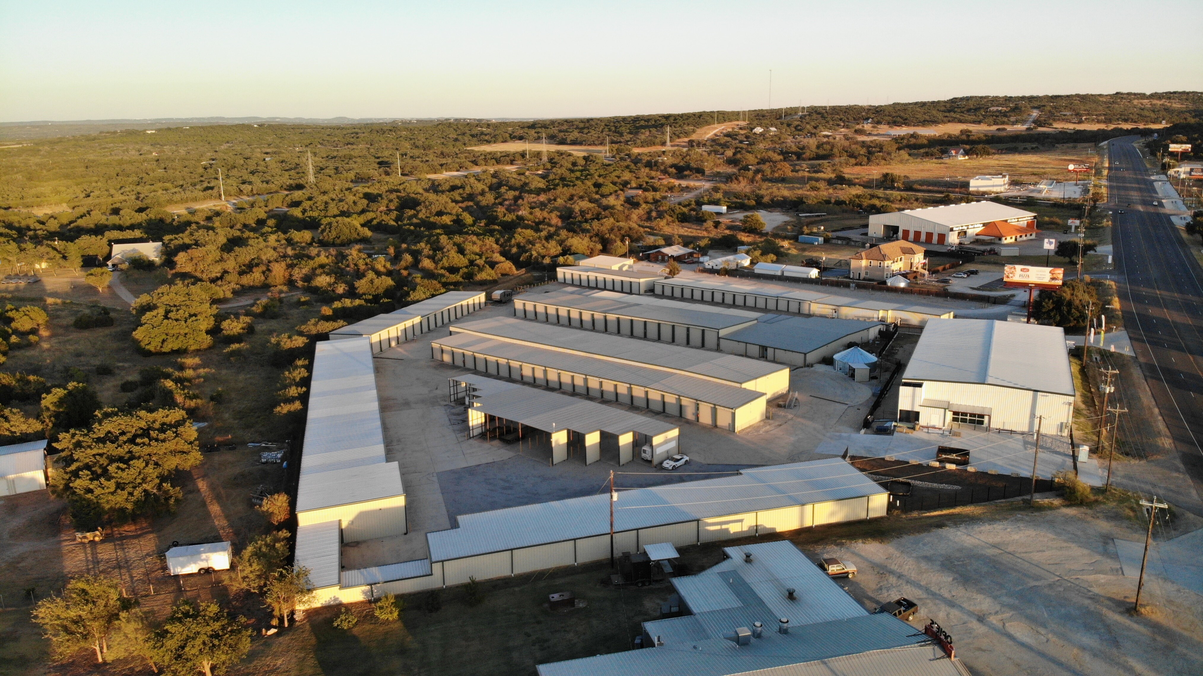 Aerial view of Spicewood Super Storage facility near Marble Falls, TX, showing multiple storage buildings, RV parking, and proximity to Highway 71.